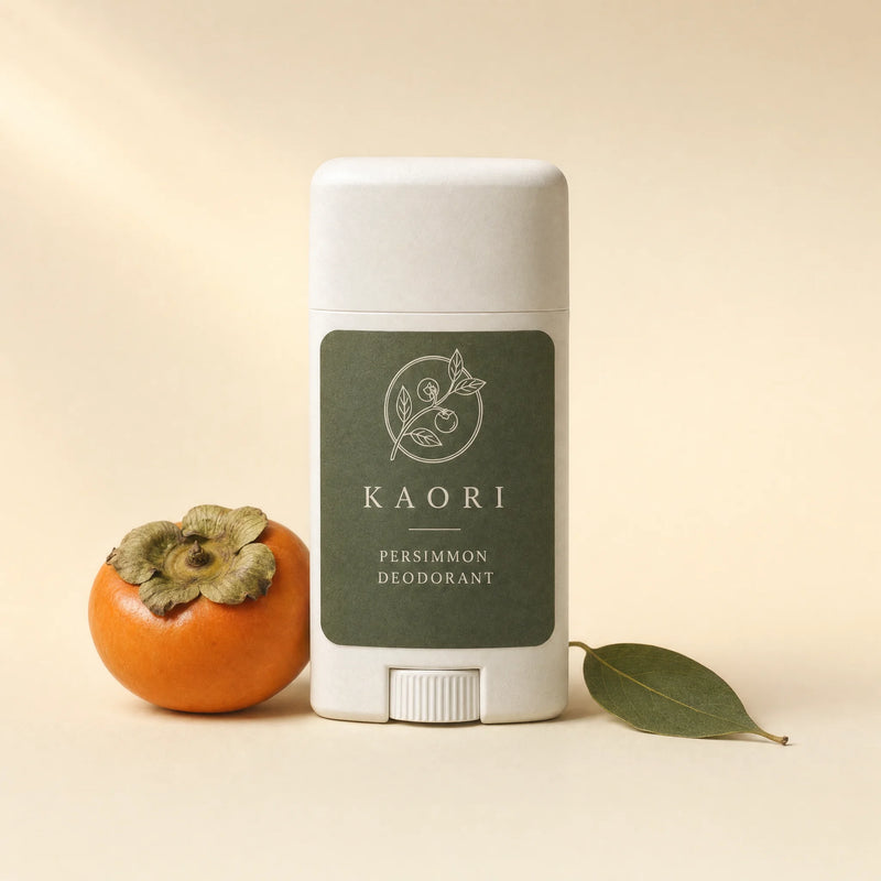 Kaori Persimmon Deodorant stick beside a ripe persimmon