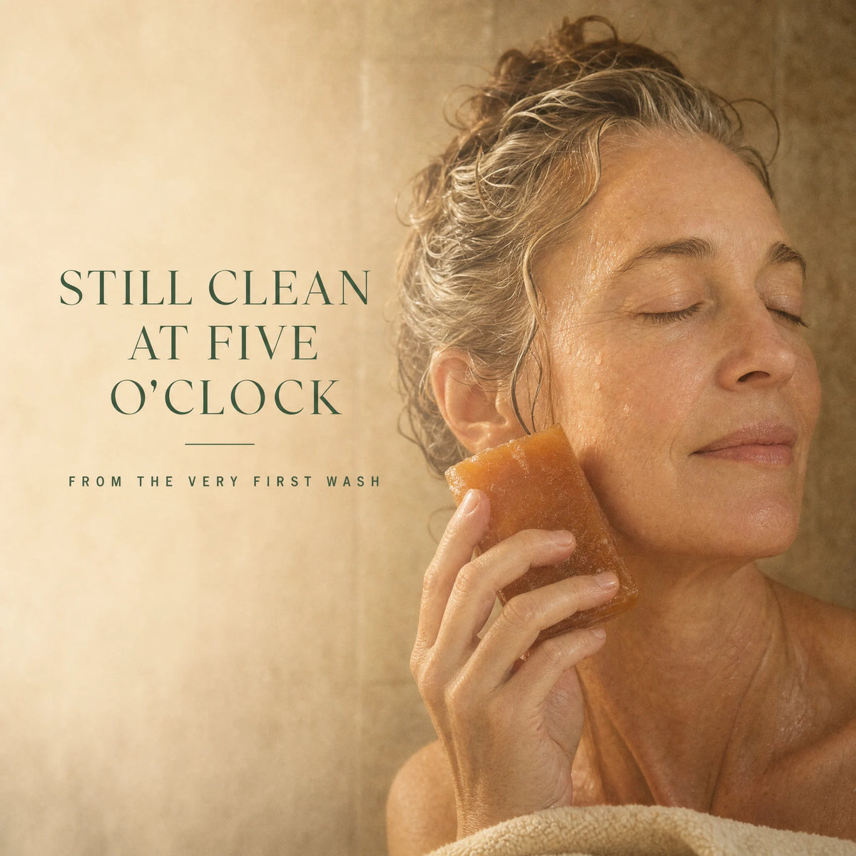 A woman in the shower holding the Kaori persimmon soap bar